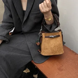 Retro brown suede bucket bag with top handle and metal lock clasp for women daily commute.