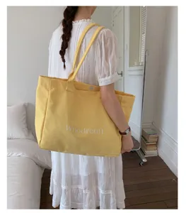 Casual yellow canvas tote bag for women, large capacity shoulder bag for daily commute.