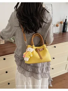 Stylish Korean style women handbag with cute bear pendant, trendy color block detail for daily use.