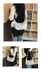Detailed view of large capacity hobo shoulder bag in light grey, featuring cute bear pendant.