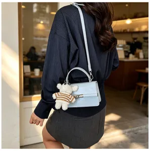 Chic light blue crossbody bag for women, stylish top handle small square bag with cute bear pendant.