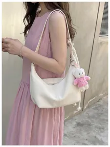 White leather hobo shoulder bag detail with cute knit bear pendant, stylish casual crossbody.