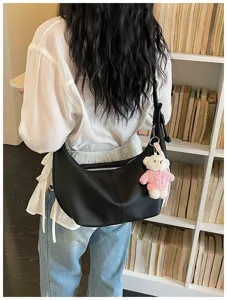 Stylish black leather shoulder bag with bear charm, large capacity dumpling hobo bag for women daily.