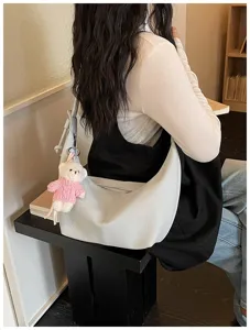 Detailed view of grey hobo shoulder bag with cute bear charm for daily casual wear.