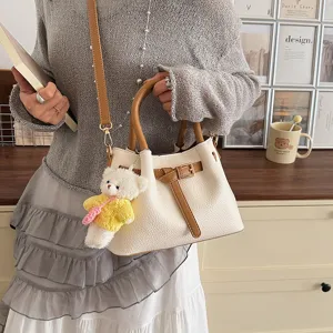Korean style contrast color shoulder bag for women, stylish bucket handbag with cute bear pendant.