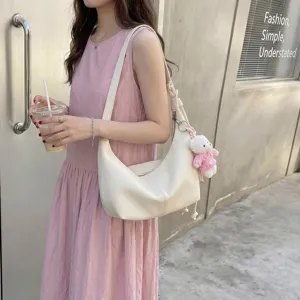 Stylish white hobo shoulder bag for women, minimalist daily dumpling bag with cute bear charm.