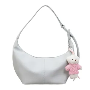 Stylish light grey dumpling shoulder bag with a cute pink sweater bear pendant for women.