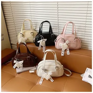 Korean style fashion bowling handbag with cute pearl bow decor, versatile shoulder bag.