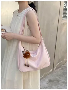 Simple large capacity women shoulder bag casual commute pink hobo bag with cute plush pendant.