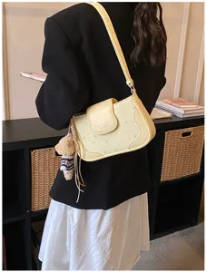 Yellow underarm shoulder bag for women, chic star embossed leather purse with cute bear charm.