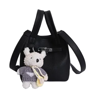 Black litchi grain bucket handbag with lock design and cute bear pendant for daily use