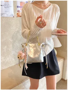 Chic silver quilted shoulder bag with chain strap and cute bear charm for daily commute.