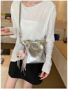 Stylish silver quilted shoulder bag with chain strap and cute bear charm for women daily commuting.