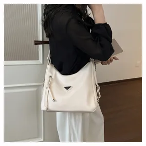 Elegante große weiße Schultertasche mit stilvollem Metall-Dreieckslogo und modischem Quasten-Design.