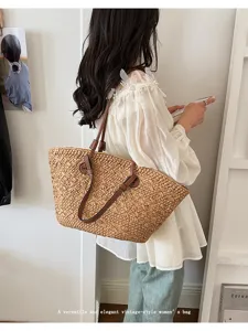 Vue détaillée du sac cabas en paille décontracté avec poignées en cuir marron pour plage.