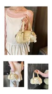 Cream patent leather bowling handbag with pearl heart charm, stylish daily commute shoulder bag.