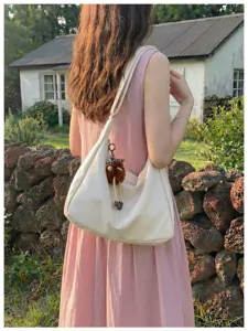 Stylish large capacity women hobo shoulder bag with cute pendant, perfect daily commuter wear.