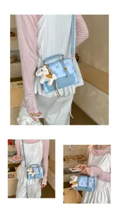 Chic light blue crossbody small square bag detail, featuring cute horse charm and flap design.