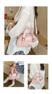 Chic pink PU leather bowling handbag, versatile shoulder and crossbody bag with pearl charm.