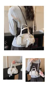 Stylish women's bowling handbag with pearl ribbon pendant, versatile shoulder and crossbody bag.