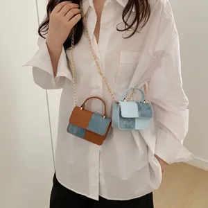 Trendy denim PU leather mini crossbody shoulder handbag with gold chain strap for women.