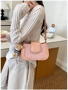 Pink star pattern underarm shoulder bag with cute bear pendant, stylish casual daily accessory.