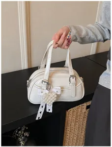 Stylish white bowling handbag for women, versatile PU leather shoulder and crossbody bag.