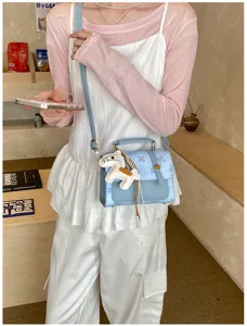 Chic women's crossbody bag with cute horse charm, stylish mini square handbag for daily wear.