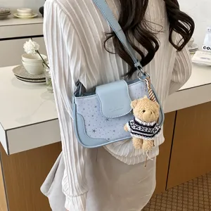 Women's blue shoulder bag casual underarm handbag with cute bear pendant and star pattern.