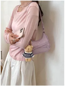 Purple stylish shoulder bag for women with star embellishments and cute bear pendant.