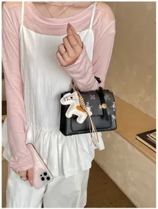 Fashionable women's handbag with stylish print and cute charm, perfect for daily wear.