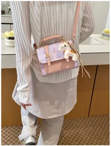 Chic pastel purple pink crossbody satchel bag with cute horse charm for stylish spring daily