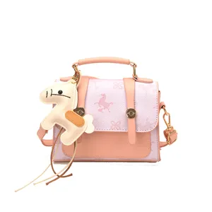 Chic pink small crossbody bag for women, stylish handbag with cute horse charm and top handle.