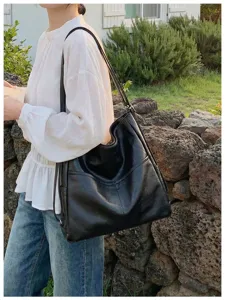 Black PU leather casual shoulder tote bag detail view, multi-pocket daily lifestyle design.
