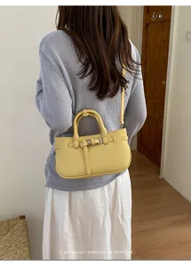 Detailed view of the women vintage yellow leather shoulder bag with chic metal buckle.