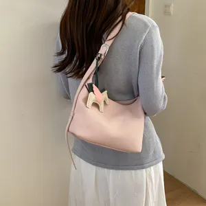 Pink leather shoulder underbag women stylish casual purse with cute winged horse charm.