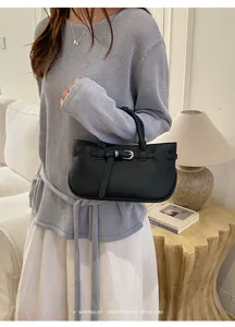 Black retro PU leather handbag detail, stylish belt buckle design, elegant daily wear accessory.
