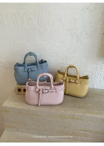 Minimalist retro women handbag detail, textured PU leather shoulder cross-body bag.
