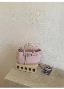 Retro pink lychee pattern handbag for women, chic shoulder and crossbody bucket style.