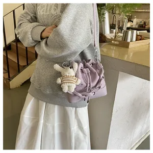 Korean pleated bucket bag for women, trendy leather shoulder crossbody bag with cute pendant.