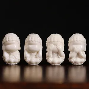 Detailed close-up of four cute white zen little monk figurines, excellent craftsmanship and design.