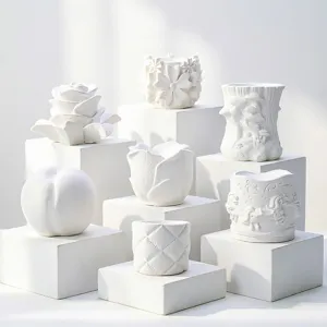 Detailed view of various white 3D floral and fruit shaped aroma diffuser stones or molds.
