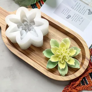 Close-up of 3D double layer lotus silicone mold and finished candle detail on wooden tray.