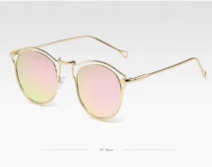 Vue détaillée de lunettes de soleil rondes monture métal doré verres miroirs roses.