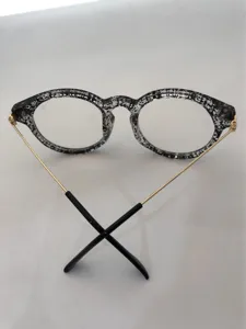 Stylish retro round eyeglasses frame featuring unique speckled pattern with gold metal temples.