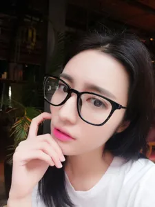 Stylish black square frame glasses worn by model, showing clear optical frame details.