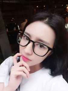 Close-up detail of stylish black frame optical glasses worn by a model, modern unisex design.