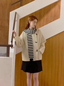 Chic black and white striped scarf integrated coat matching a black skirt, stylish outerwear.