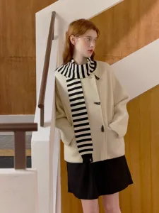Chic off-white duffle coat paired with a creative black and white striped scarf for women.