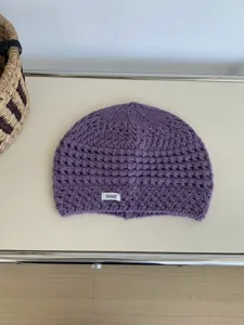 Purple knitted hollow beanie autumn winter warm hat detail shot, cozy fashion accessory